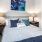 Bedroom has a window and fits a queen sized bed and two nightstands