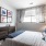 bedroom with a dresser and a large window