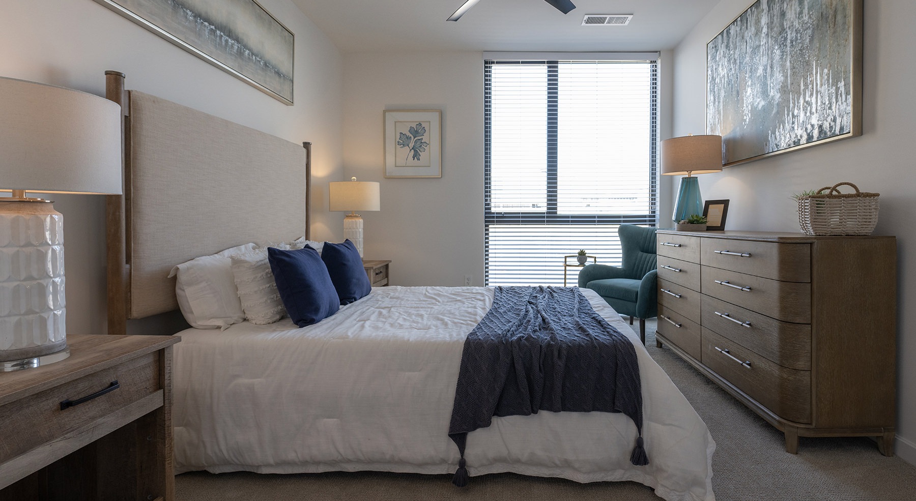 bedroom with bed dresser and large window